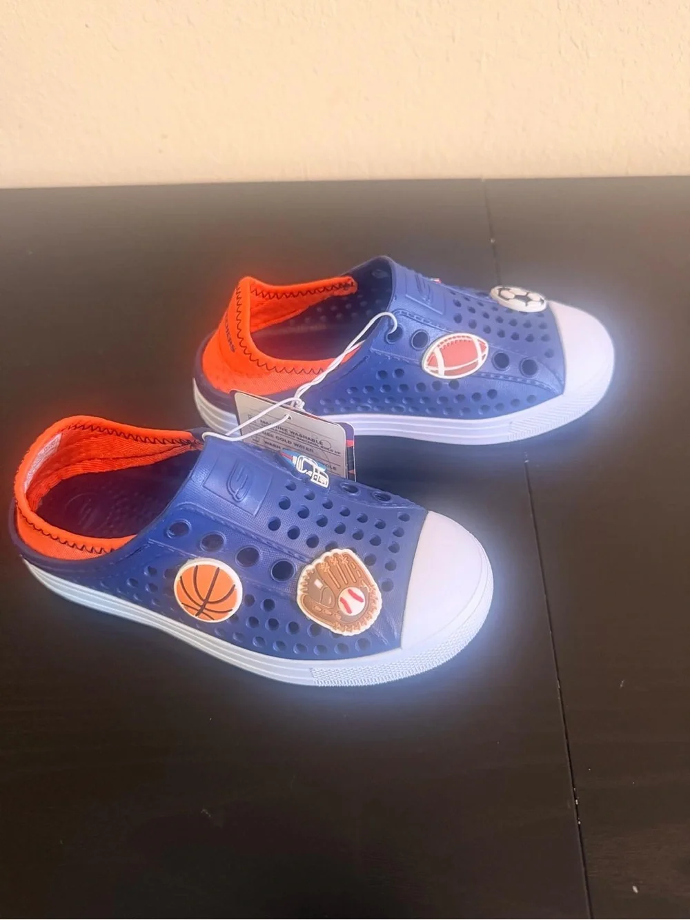 Skechers Kids Navy and Orange Slip-On Sneakers with Sports Patches